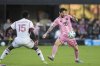 Inter Miami forward Lionel Messi (10) controls the ball defended by Toronto FC defender Nicksoen Gomis (15) during the first half of an MLS soccer match, Sunday, April 6, 2025, in Fort Lauderdale, Fla. (AP Photo/Rebecca Blackwell)