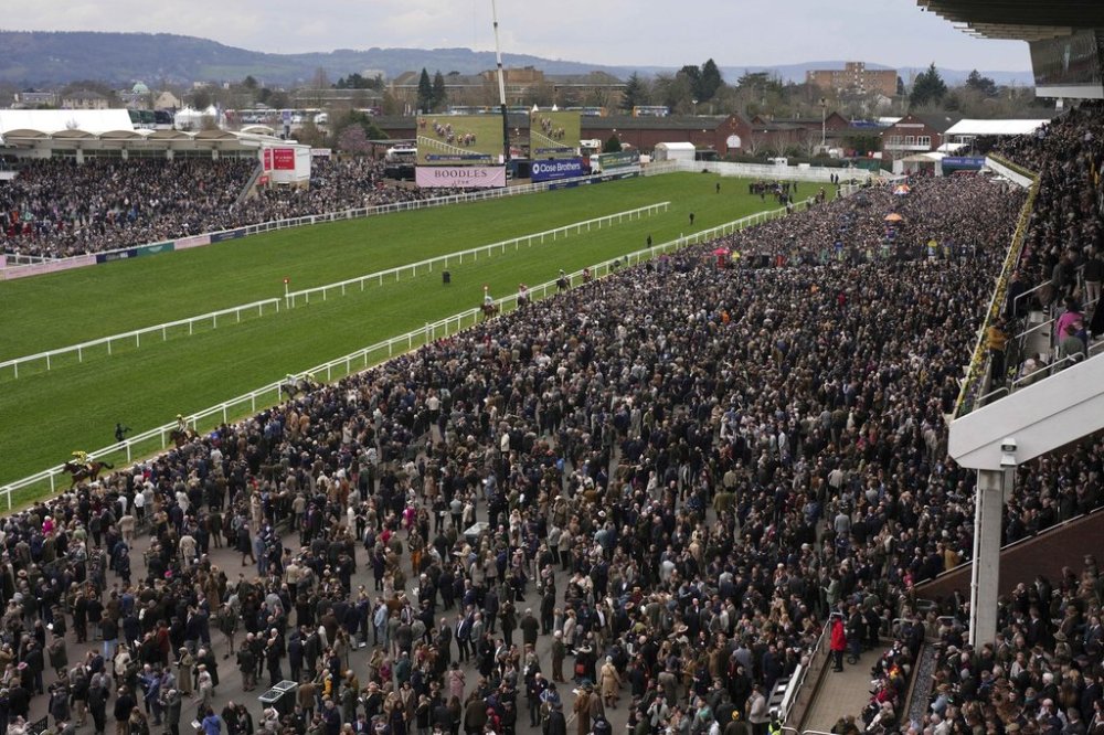 People arrive to watch the final day of the British Horse Racing Cheltenham Festival at Cheltenham Racecourse, England, Friday, March 14, 2025. (AP Photo/Dave Shopland)