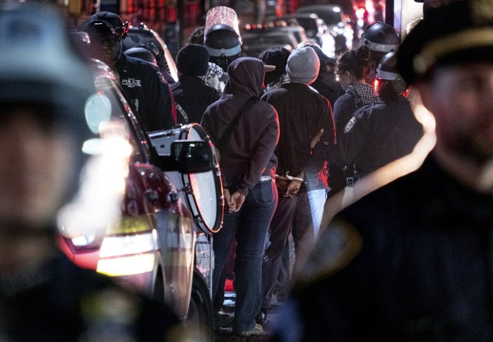 FILE - New York City police officers take people into custody near the Columbia University campus in New York Tuesday, April 30, 2024, after a building taken over by protesters earlier in the day was cleared, along with a tent encampment. (AP Photo/Craig Ruttle, File)