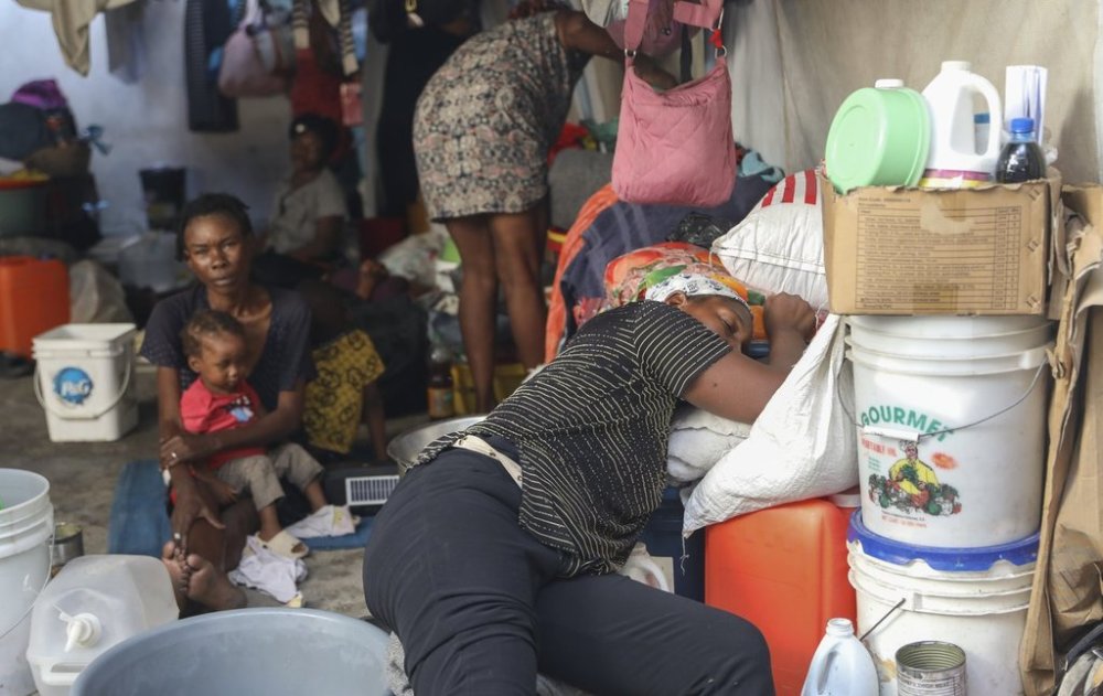A displaced woman rests in a shelter for people fleeing their homes to escape gang violence, in Port-au-Prince, Haiti, Friday, Feb. 28, 2025.(AP Photo/Odelyn Joseph)