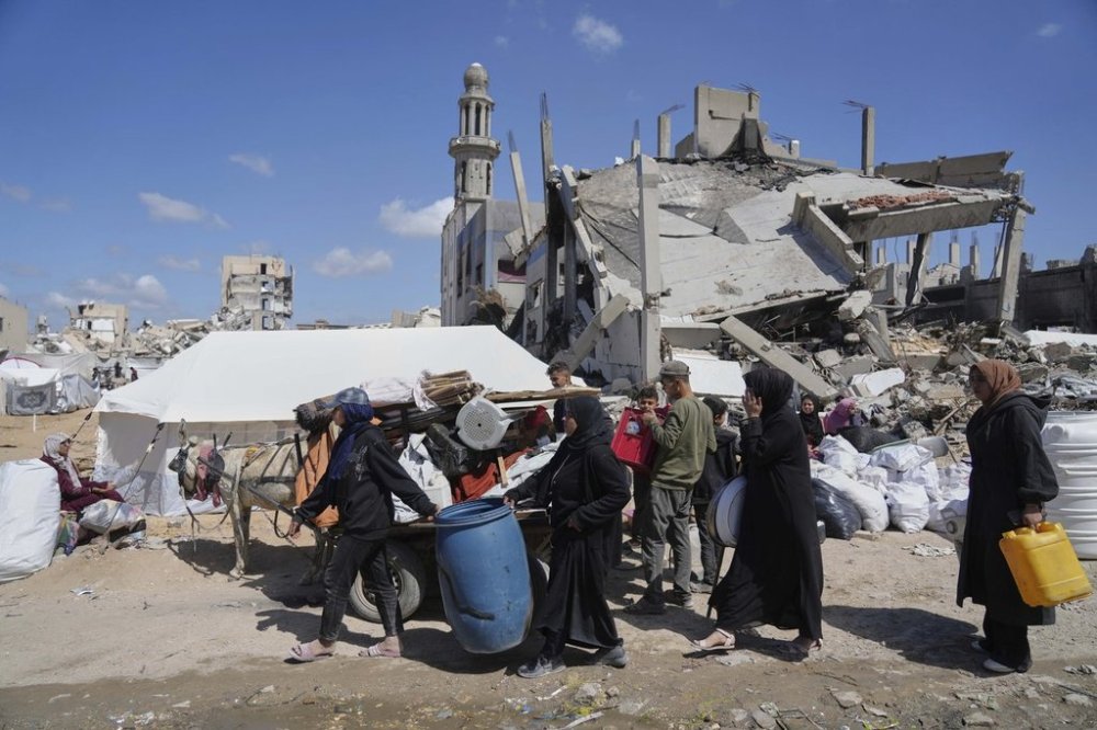 Displaced Palestinians, carrying their belongings traveling from Beit Hanoun to Jabaliya, a day after Israel's renewed offensive in the Gaza Strip, Wednesday, March 19, 2025. (AP Photo/Jehad Alshrafi)