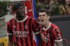 AC Milan's Tammy Abraham , left,celebrates after he scored his side's first goal during an Italian Cup semi final first leg soccer match between AC Milan and Inter Milan at the San Siro stadium, in Milan, Italy, Wednesday, April 2, 2025. (AP Photo/Antonio Calanni)