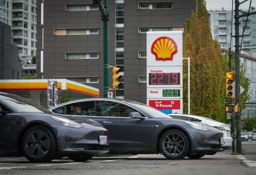 Three Tesla electric vehicles drive past a gas station in Vancouver on Saturday, May 14, 2022. THE CANADIAN PRESS/Darryl Dyck