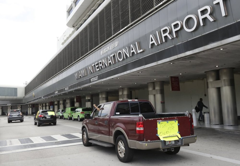 FILE - A caravan of airport workers protest against layoffs and inadequate personal protective equipment by airline contractor Eulen America, Tuesday, May 12, 2020, at Miami International Airport in Miami. (AP Photo/Wilfredo Lee, File)