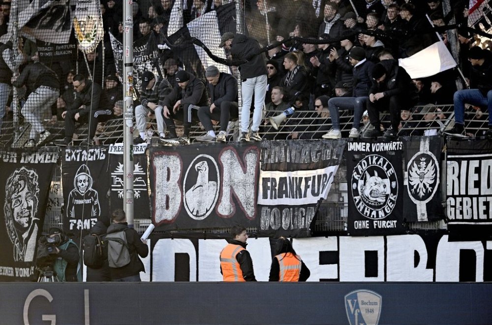 Frankfurt fans waits for a delayed kick-off of the German Bundesliga soccer match between VfL Bochum and Eintracht Frankfurt at the Vonovia Ruhrstadion. in Bochum, Germany, Sunday, March 16, 2025. (Anke Wälischmiller/dpa via AP)