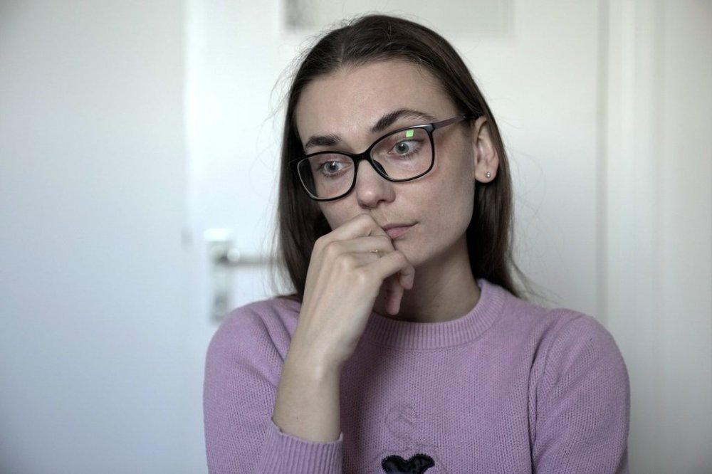 Liusiena Zinovkina, 32, sits in her room in Berlin, Germany, March 19, 2025. She fled to Germany from Ukraine, where her husband was arrested by invading Russian forces in May 2023. (AP Photo/Ebrahim Noroozi)