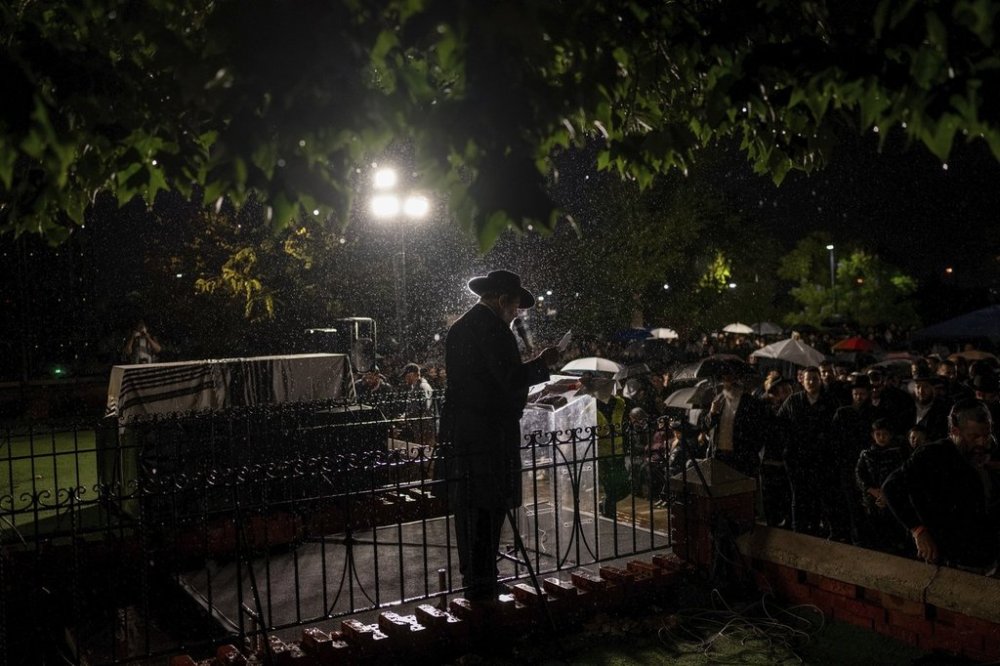 FILE - A rabbi delivers an eulogy next to the coffin containing the remains of Israeli-Moldovan rabbi Zvi Kogan in Kfar Chabad, Israel, Monday Nov. 25, 2024. (AP Photo/Ohad Zwigenberg, File)