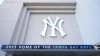 A Tampa Bay Rays banner hangs near a New York Yankees logo outside George M. Steinbrenner Field during a stadium tour Wednesday, March 26, 2025, in Tampa, Fla. (AP Photo/Chris O'Meara)