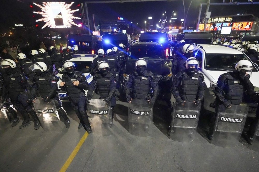 Serbian police officers block a bridge as students and citizens march to protest the deaths of 15 people killed in the November collapse of a train station canopy in Belgrade, Serbia, Saturday, March 8, 2025. (AP Photo/Darko Vojinovic)