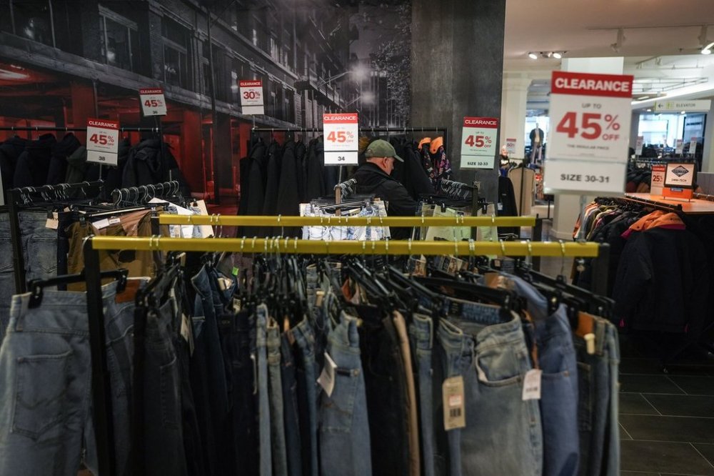 Clearance signs are displayed on racks of clothing at the flagship downtown Hudson's Bay store, in Vancouver, on Monday, March 24, 2025. THE CANADIAN PRESS/Darryl Dyck