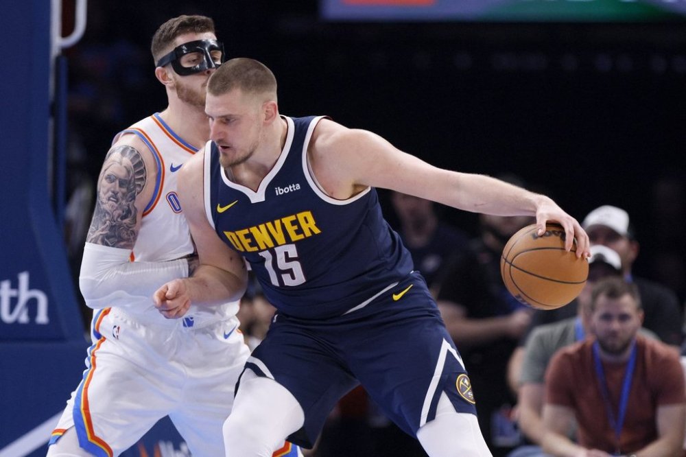 Denver Nuggets center Nikola Jokic (15) goes to the basket against Oklahoma City Thunder center Isaiah Hartenstein during the first half of an NBA basketball game Monday, March 10, 2025, in Oklahoma City. (AP Photo/Nate Billings)