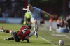 Manchester City's Erling Haaland, right, duels for the ball with Bournemouth's Lewis Cook during the English FA Cup quarterfinal soccer match between Bournemouth and Manchester City at the Vitality stadium in Bournemouth, England, Sunday, March 30, 2025. (AP Photo/Ian Walton)