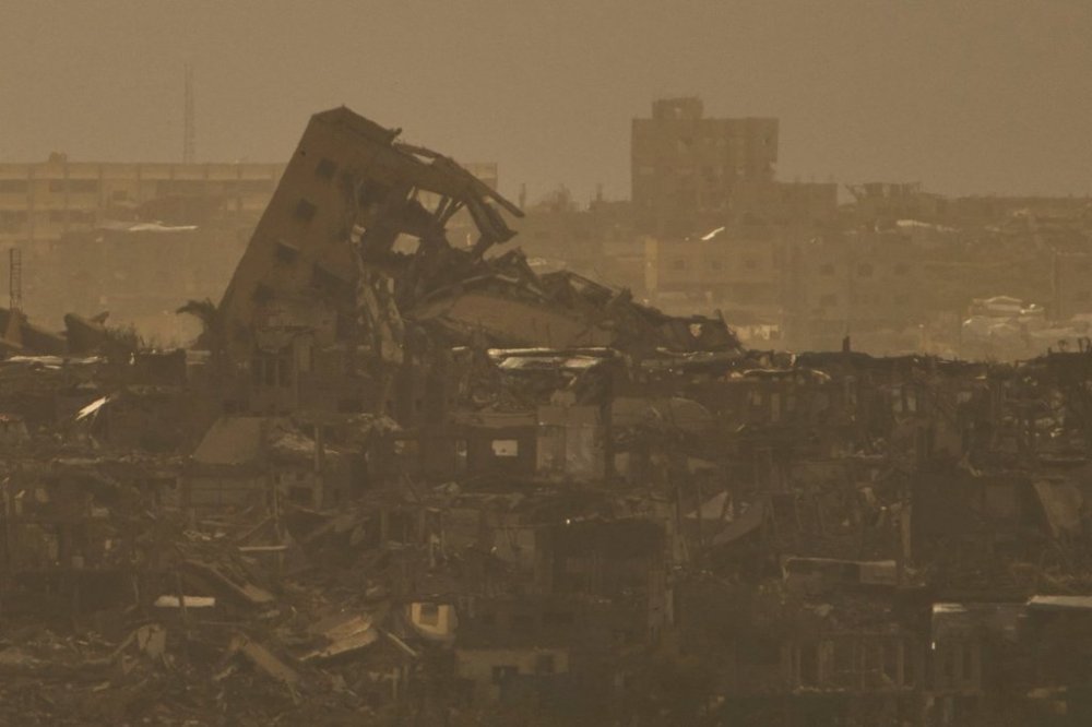 Buildings that were destroyed during the Israeli ground and air operations stand in northern of Gaza Strip as seen from southern Israel, Tuesday, April 1, 2025. (AP Photo/Leo Correa)