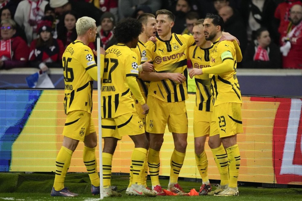 Dortmund players celebrate after a goal during the Champions League round of 16 second leg soccer match between Lille and Borussia Dortmund in Villeneuve-d'Ascq , Wednesday, March 12, 2025. (AP Photo/Michel Euler)