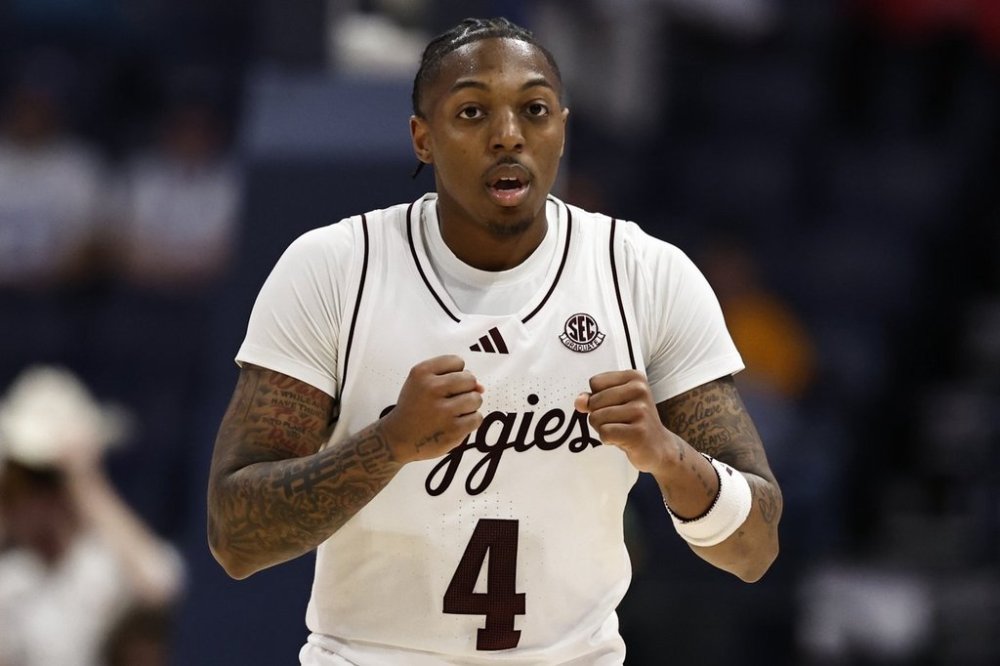 Texas A&M guard Wade Taylor IV (4) reacts ti his three-point shot against Texas during the second half of an NCAA college basketball game in the second round of the Southeastern Conference tournament, Thursday, March 13, 2025, in Nashville, Tenn. (AP Photo/Wade Payne)