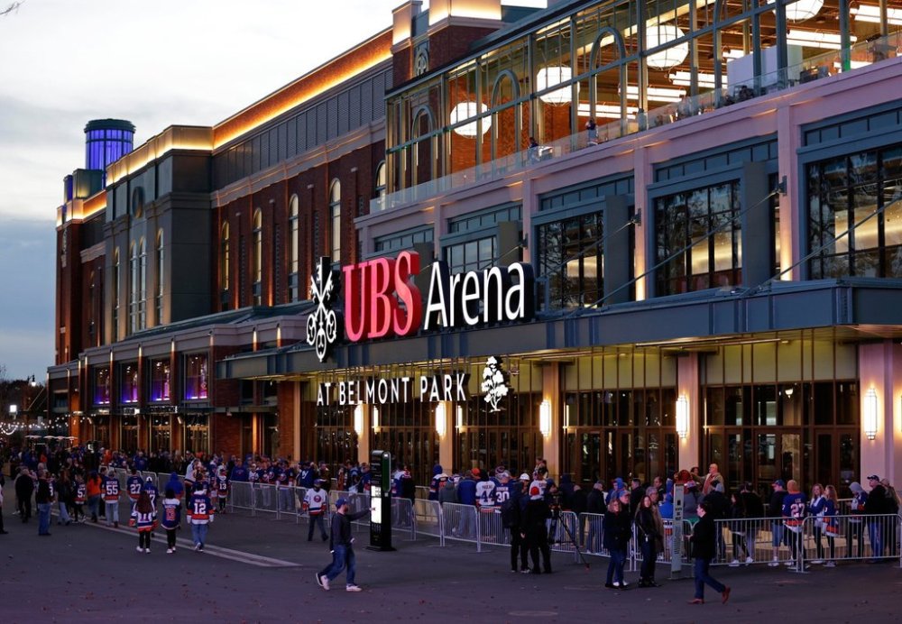 FILE - Fans wait to enter the new UBS Arena for the first New York Islanders NHL hockey game against the Calgary Flames, on Nov. 20, 2021, in Elmont, N.Y. (AP Photo/Adam Hunger, File)