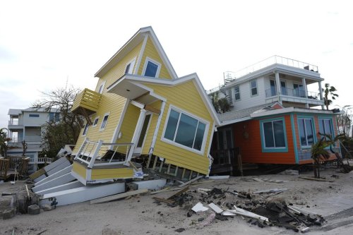 FILE - A house lies toppled off its stilts after the passage of Hurricane Milton, in Bradenton Beach on Anna Maria Island, Fla., Oct. 10, 2024. (AP Photo/Rebecca Blackwell, File)