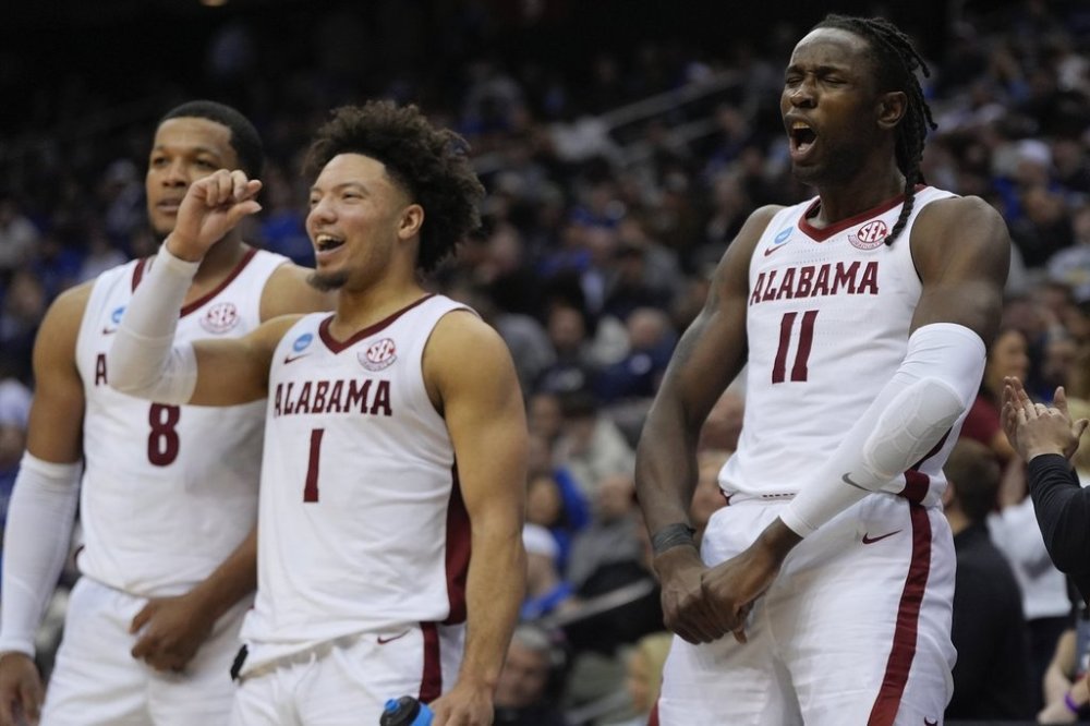 Alabama center Clifford Omoruyi (11), guard Mark Sears (1) and guard Chris Youngblood (8) react during the second half of a Sweet 16 round NCAA college basketball tournament game against Brigham Young, Thursday, March 27, 2025, in Newark, N.J. (AP Photo/Julia Demaree Nikhinson)