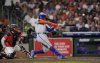 New York Mets' Juan Soto, right, hits a home run as Houston Astros catcher Yainer Diaz reaches for the pitch during the third inning of a baseball game Friday, March 28, 2025, in Houston. (AP Photo/David J. Phillip)