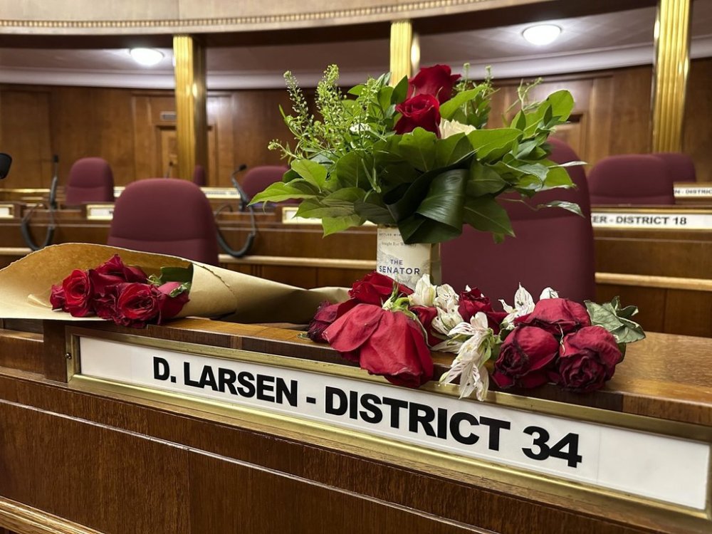 FILE - Flowers sit on the Senate desk of late North Dakota state Sen. Doug Larsen, on Oct. 6, 2023, in the state Capitol in Bismarck, N.D. (AP Photo/Jack Dura, file)