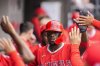 Los Angeles Angels designated hitter Jorge Soler celebrates in the dugout after scoring on an RBI single by Yoán Moncada during the eighth inning of a baseball game against the Chicago White Sox, Saturday, March 29, 2025, in Chicago. (AP Photo/Erin Hooley)