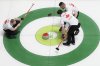 Canada's Ben Hebert and Brett Gallant usher a stone from Marc Kennedy towards the button as skip Brad Jacobs looks on during play against Sweden at the BKT World Men's Curling Championship in Moose Jaw, Sask., on Tuesday April 1, 2025. THE CANADIAN PRESS/Chris Young