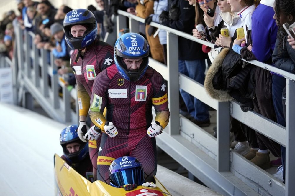 Germany's Francesco Friedrich, Matthias Sommer, Alexander Schuller and Felix Straub celebrate after finishing their run in the fourth heat of the 4-man bobsled race during the bobsled world championships, Saturday, March 15, 2025, in Lake Placid, N.Y. (AP Photo/Seth Wenig)