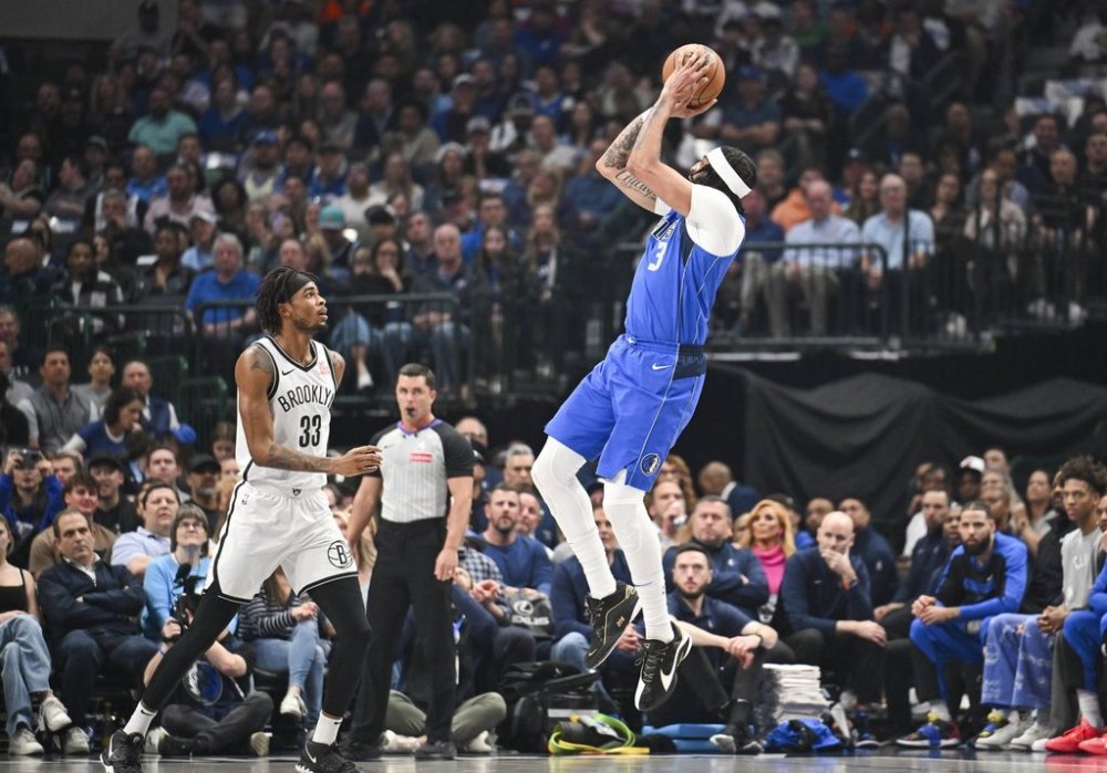 Dallas Mavericks forward Anthony Davis takes a jump shot over Brooklyn Nets center Nic Claxton (33) during the first half of an NBA basketball game, Monday, March 31, 2025, in Dallas, Texas. (AP Photo/Albert Pena)