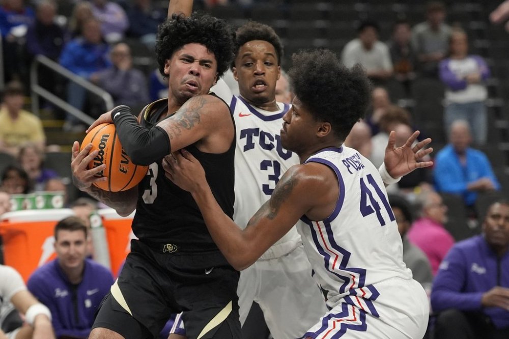 Colorado's Julian Hammond III, left, controls the ball as TCU's Vasean Allette (3) and Jace Posey (41) defend during the second half of an NCAA college basketball game in the first round of the Big 12 Conference tournament, Tuesday, March 11, 2025, in Kansas City, Mo. (AP Photo/Charlie Riedel)