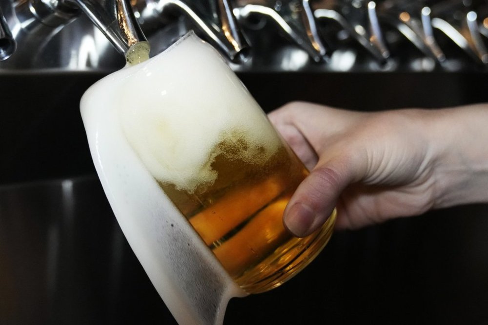 FILE - A bartender pours a craft beer at the Liquid Love Brewing in Buffalo Grove, Ill., Thursday, Feb. 9, 2022. (AP Photo/Nam Y. Huh, File)