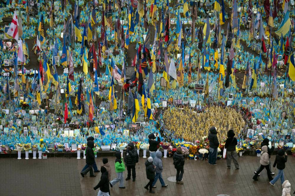 The Associated Press
People walk past the memorial to fallen soldiers in Independence Square in Kyiv, Ukraine, in November.