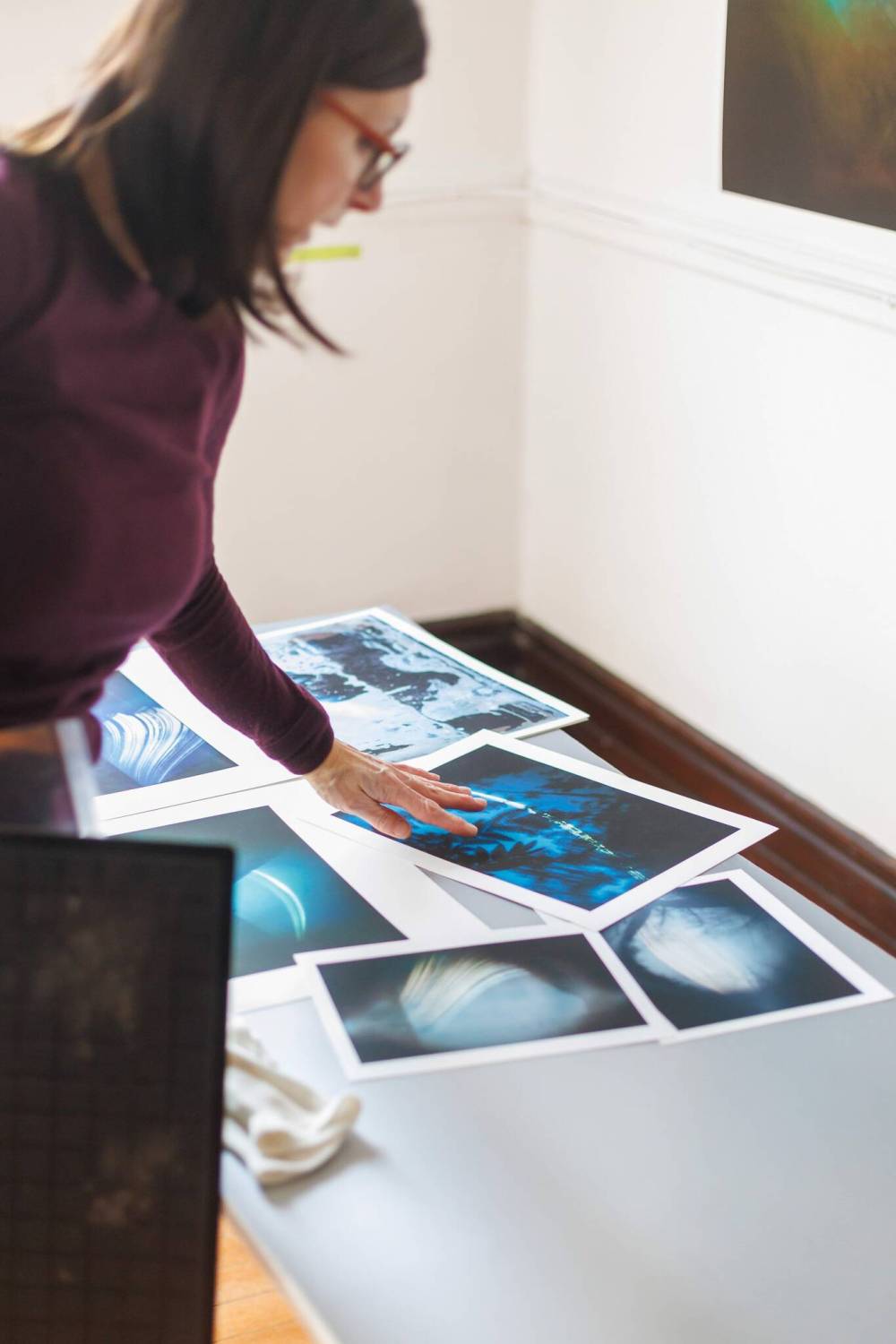 MIKE DEAL / FREE PRESS
Stuart in her studio with examples of her work that have been scanned and printed for exhibition.