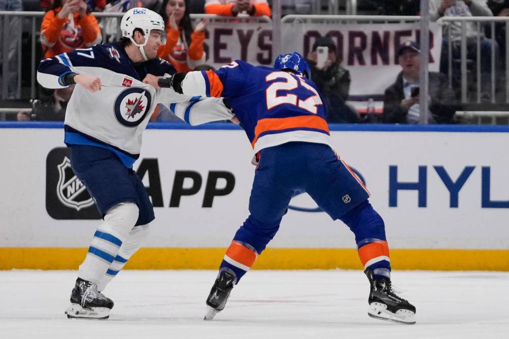 Frank Franklin II / The Associated Press
The Jets’ Adam Lowry fights with the Islanders’ Anders Lee in the first period.