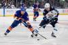 Frank Franklin II / The Associated Press
                                Casey Cizikas (left) of the Islanders and the Jets’ Mark Scheifele battle for the puck Tuesday night in Elmont, N.Y.