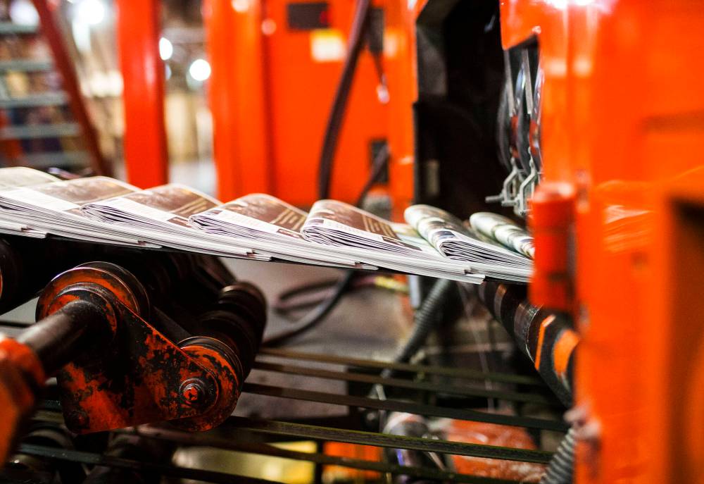 Newspapers running off the presses in the Free Press pressroom. (Mikaela MacKenzie / Free Press files)
