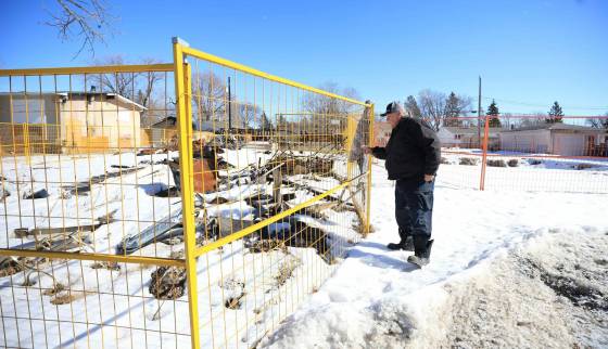 Earnest Prescotte stands next to the fenced in lot where his home once stood. (Ruth Bonneville / Free Press)