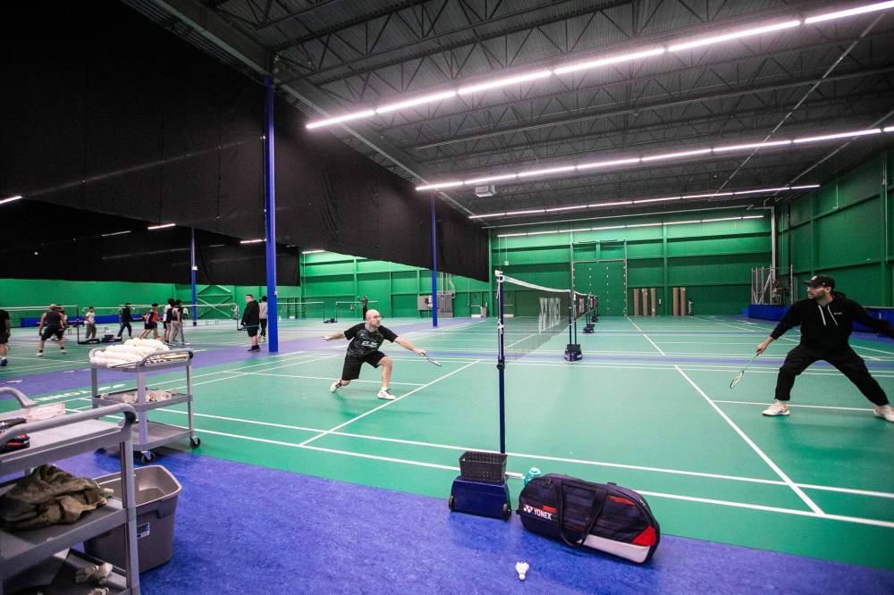 MIKAELA MACKENZIE / FREE PRESS
Dale Kinley, manager and co-owner of C1/DK Badminton (left), rallies Friday with fellow coach Kyi Nichols. The 31,000-square-foot centre helps fill a void in the city, says the executive director of the Manitoba Badminton Association.