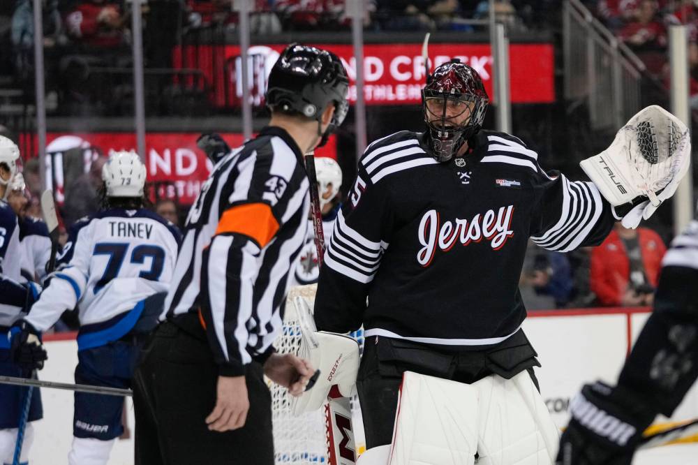 Frank Franklin II / The Associated Press
Devils goaltender Jacob Markstrom argues for a call with referee Mitch Dunning after the Jets scored a goal in the first period.