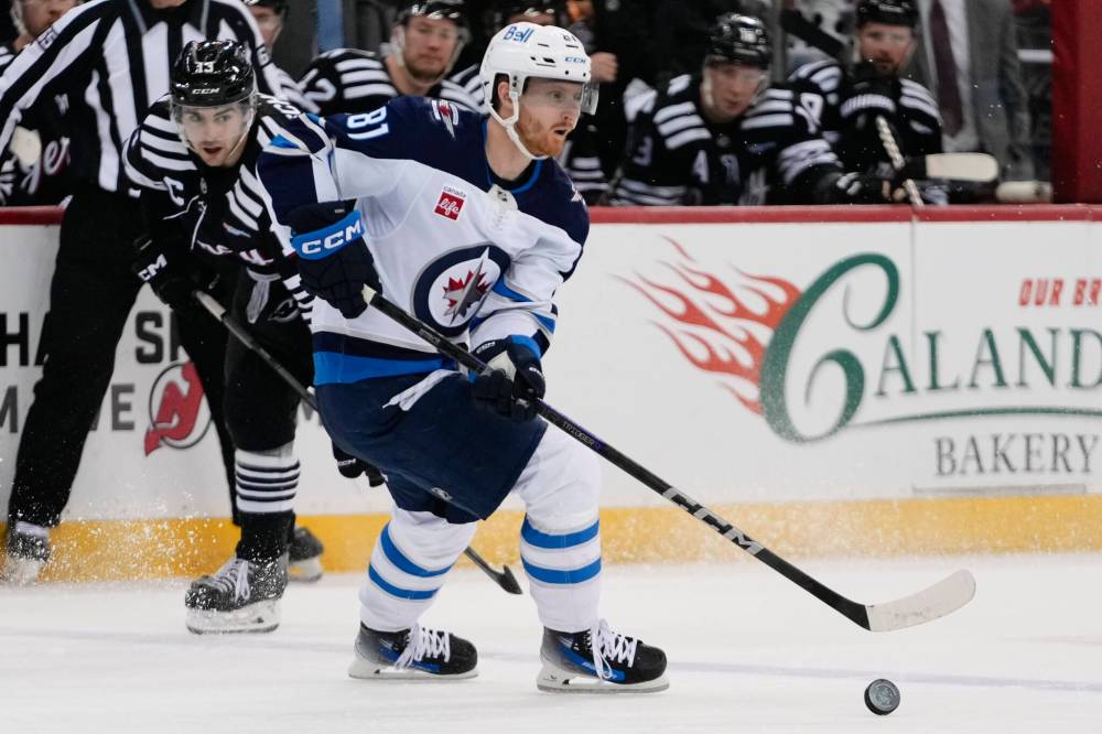 Frank Franklin II / The Associated Press
Winnipeg Jets’ Kyle Connor evades New Jersey Devils’ Nico Hischier in the third period.