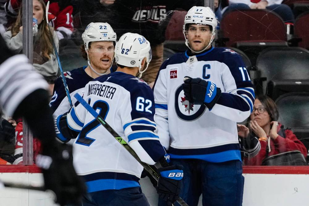 Frank Franklin II / The Associated Press
Winnipeg Jets' Adam Lowry celebrates with teammates after scoring a goal during the third period.