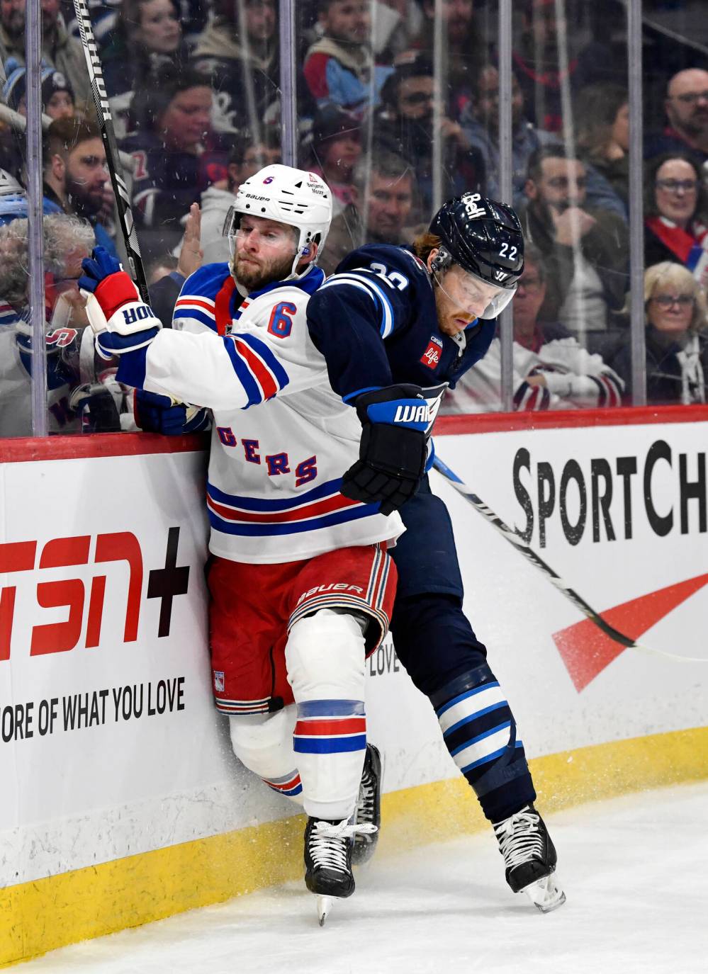 Fred Greenslade / THE CANADIAN PRESS
New York Rangers’ Zac Jones is checked by Winnipeg Jets’ Mason Appleton in the second period.