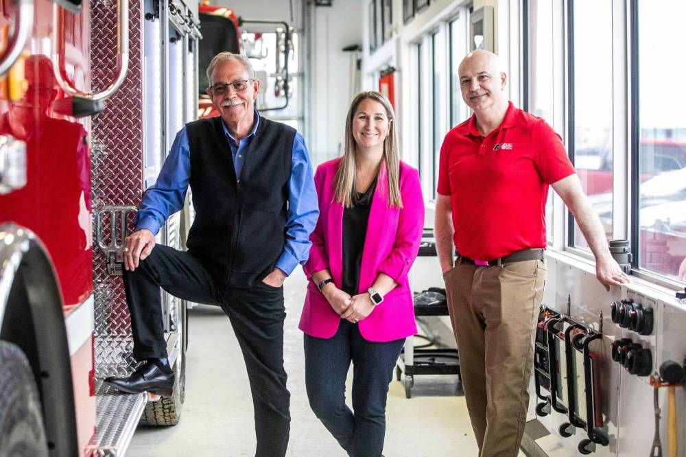 MIKAELA MACKENZIE / FREE PRESS
From left, Brian Nash, vice president of sales, Lisa Suche, purchasing manager, and Robert Pike, corporate services manager at Fort Garry Fire Trucks.