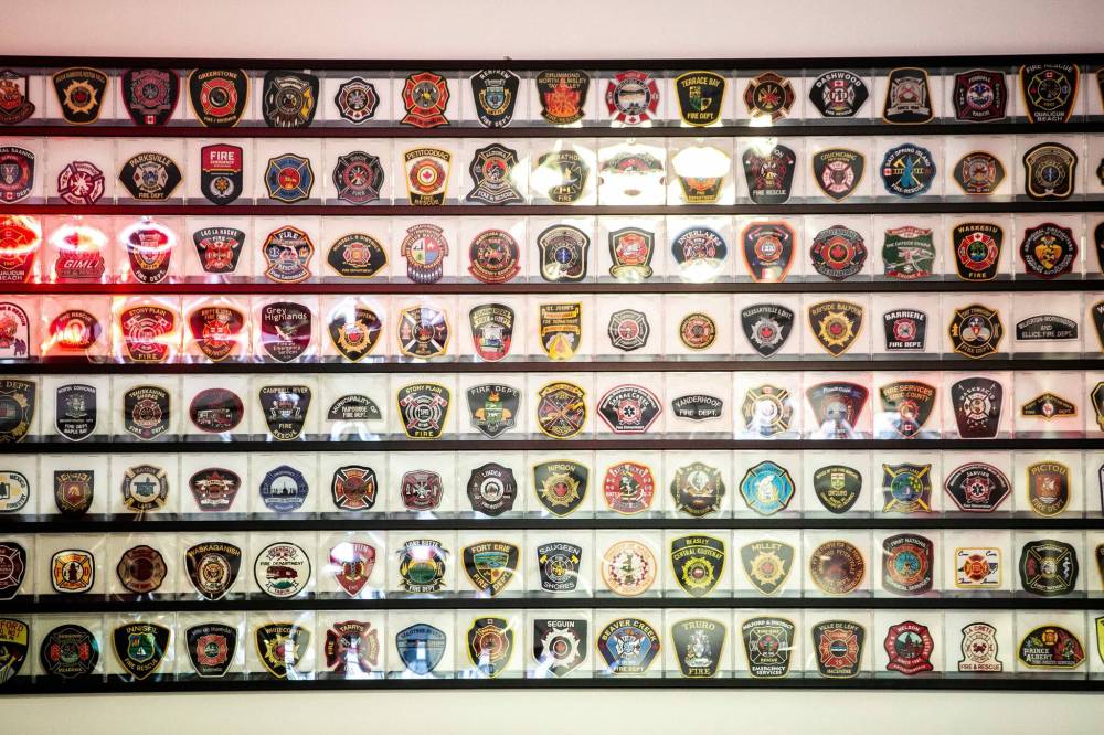 MIKAELA MACKENZIE / FREE PRESS
A display of fire department patches in the Fort Garry Fire Trucks showroom. Each patch represents a company that has a truck made by the Winnipeg manufacturer.