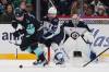 Seattle Kraken right wing Jani Nyman (38) tries to maneuver around Winnipeg Jets defenseman Josh Morrissey (44) as goaltender Eric Comrie (1) looks on during the third period of an NHL hockey game Sunday, March 16, 2025, in Seattle. (Lindsey Wasson / The Associated Press)