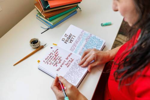 MIKE DEAL / FREE PRESS
                                Murata flips through one of her journals.