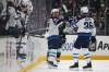 LINDSEY WASSON) / THE ASSOCIATED PRESS
                                Winnipeg Jets left wing Kyle Connor (centre) is greeted by teammate Morgan Barron (right) after scoring against the Seattle Kraken Sunday night. Connor will be playing in his 600th career game Tuesday, and is on pace to set a new franchise record in points.