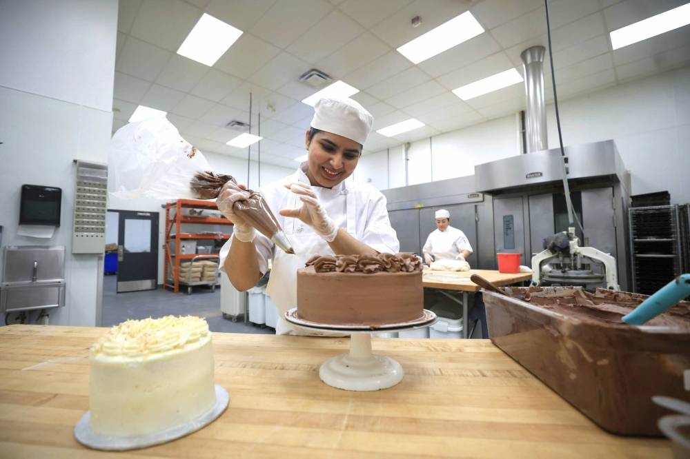 Ruth Bonneville / Free Press
A Stella’s baker decorates a layer cake at the company’s catering and restaurant hub at 1100 Waverley St. ‘We still want to be that local café that serves fresh, healthy, local, quality food,’ vice-president of operations Rob Del Grosso says.