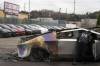 Lindsey Wasson / The Associated Press Files
                                A member of the Seattle Fire Department inspects a burned Tesla Cybertruck at a Tesla lot in Seattle March 10. Protests have devolved into vandalism at some stores.