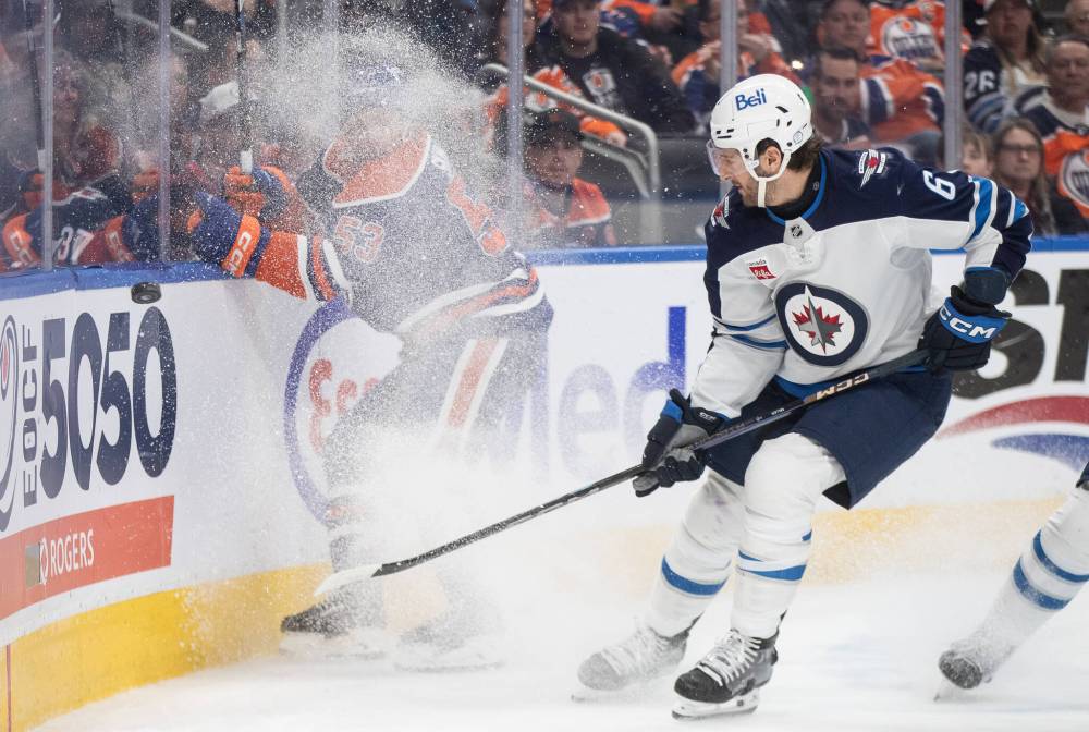 Jason Franson / THE CANADIAN PRESS
The Jets’ Colin Miller and Oilers’ Jeff Skinner battle for the puck in the second period.