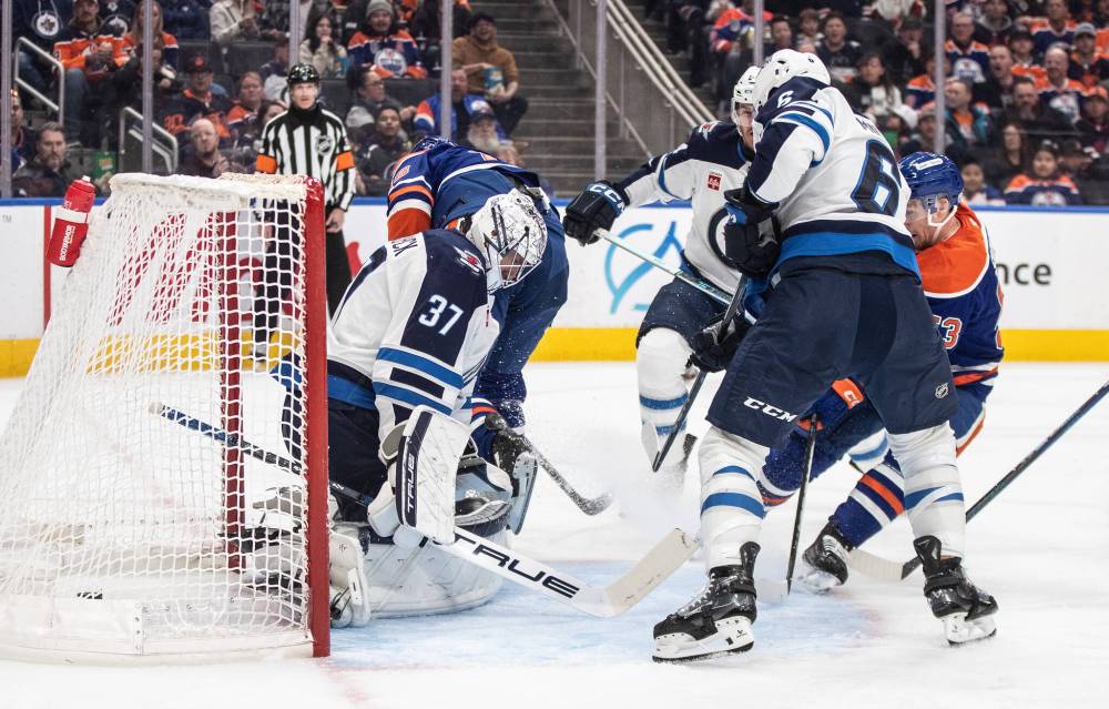 Jason Franson / THE CANADIAN PRESS
Edmonton Oilers’ Jeff Skinner scores on Winnipeg Jets goalie Connor Hellebuyck as Colin Miller defends during the second period.